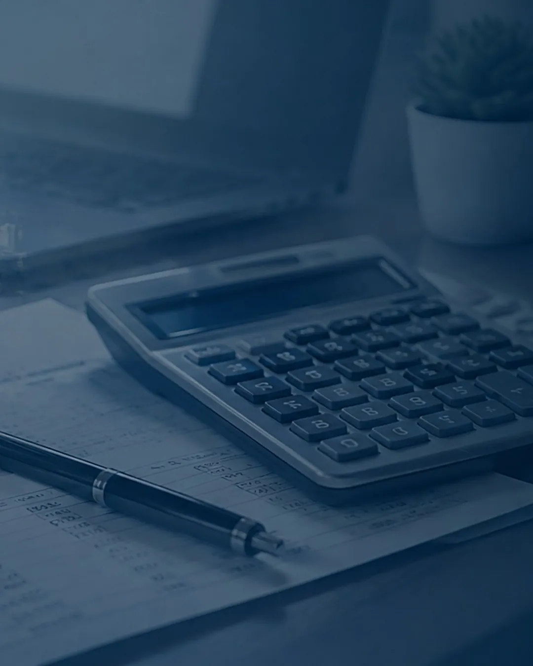 Calculator, pen and financial reports on a desk